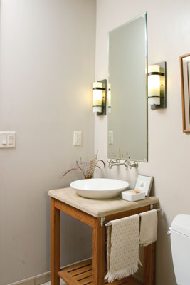 Designed by David Barrett’s wife and business partner, Betzi Bliklen Barrett, the downstairs bathroom offers charm and utility in a small space. The raised sink bowl, made by Kohler, is set into a local sandstone countertop that rests on a stand made of locust wood from Thomas and Linda’s old home.